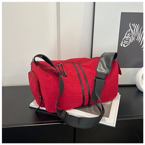 Detail view of the red nylon yoga bag showing textured fabric and black zipper straps