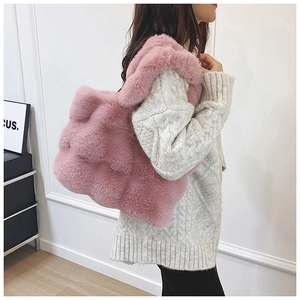 Vue détaillée d'un sac cabas en peluche rose avec texture douce sur pull en maille blanc