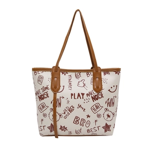 Sac fourre-tout crème avec bandoulières marron et motifs graffiti incluant ours et étoiles