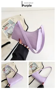 Detail view of purple crocodile pattern hobo bag with a stylish half-moon shape