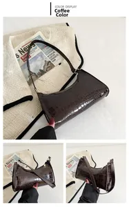Detailed close-up of coffee brown baguette bag with elegant crocodile embossed texture