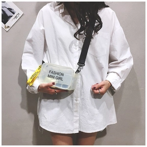 Detail of transparent PVC mini crossbody bag featuring Fashion Mini Girl text and strap