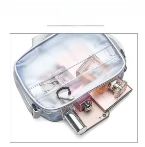 Detail showing the large capacity of the transparent blue PVC crossbody bag with essentials