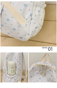 Detail view of white heart star backpack showing side pockets and metal zippers