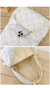 Internal view of a spacious canvas backpack featuring blue heart and star patterns on white