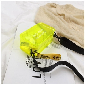 Detail of neon yellow jelly saddle bag with FASHION MINI GIRL print and black strap