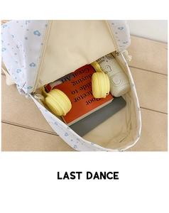 Internal storage view of white backpack showing space for books, tablet and headphones