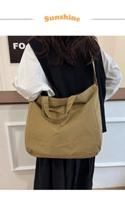 Minimalist khaki canvas tote bag on female model showing spacious casual hobo design