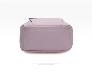 Detailed bottom view of the light purple waterproof nylon backpack showing reinforced stitching