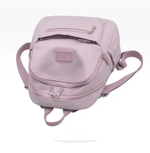 Detail view of water-resistant lavender nylon backpack with multi-zipper pockets