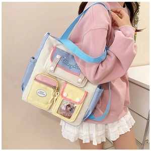 Detail of multi-pocket canvas crossbody bag with pastel contrast colors and PVC window