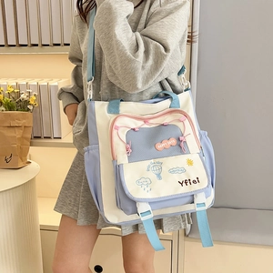 Close-up of contrast color canvas tote with cute embroidery and small front pocket