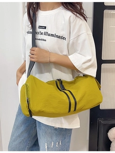 Ginger yellow nylon cylinder crossbody yoga bag with adjustable black shoulder strap