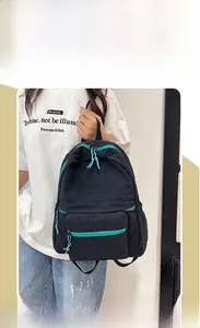 Detail of black nylon backpack with vibrant blue zipper accents and spacious pockets