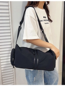 Versatile black nylon yoga sports bag with adjustable strap shown on a female model