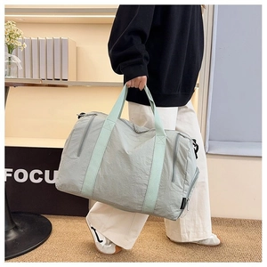 Macro detail of large gym bag featuring durable nylon fabric and reinforced webbing handles