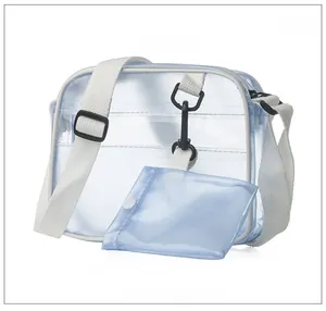 Detail view of transparent PVC crossbody bag with white nylon strap and 45-degree angle