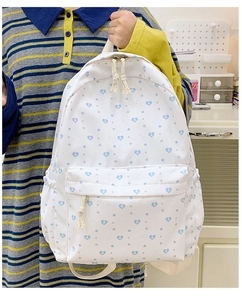 Detail of white backpack with blue heart prints and cotton rope zipper pullers