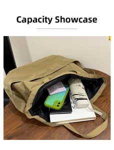 Capacity display of large khaki canvas tote bag showing books, umbrella, and essentials