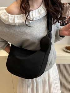 Minimalist black nylon crescent crossbody bag for women with small round coin purse charm