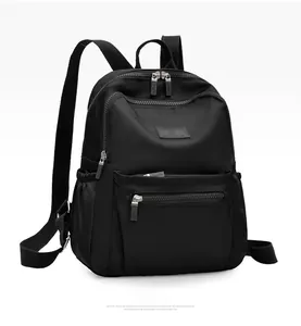 Detail view of water-resistant black nylon backpack with multi-pocket and Jingpin brand tag