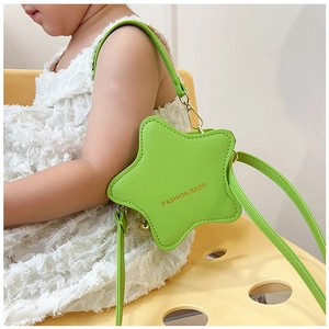 Detail of neon green star-shaped bag showing gold embossed text and fine stitching details