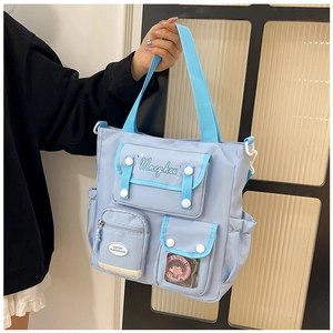 Detailed view of blue nylon crossbody bag with contrast straps and functional pockets