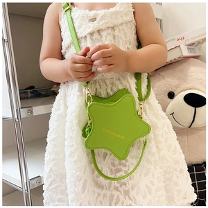 Detail of a grass green star-shaped faux leather crossbody bag for kids with gold lettering