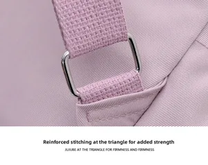 Macro detail of reinforced stitching and metal buckle on purple nylon backpack strap