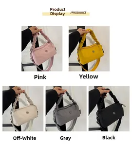 Detail display of five colors of pleated nylon handbags with flower logo and wide straps