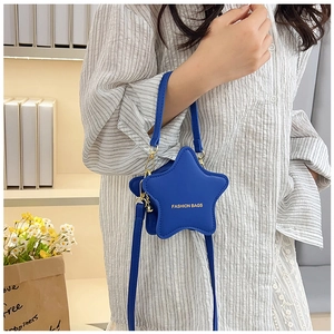 Close-up of star-shaped crossbody bag in dark blue PU leather with gold metal details