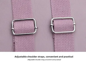 Detail of adjustable purple nylon backpack strap with silver metal buckles for easy length tuning