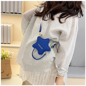 Close-up of star-shaped blue crossbody bag with adjustable strap and fashion lettering