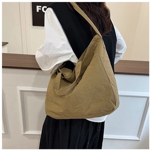 Detail of khaki large capacity canvas tote bag with soft texture and wide shoulder strap