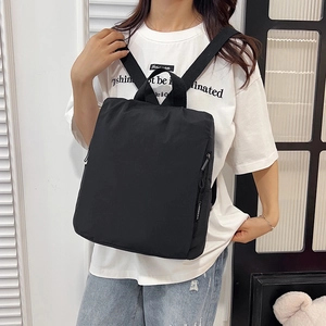 Minimalist black nylon backpack for women with adjustable straps and large capacity
