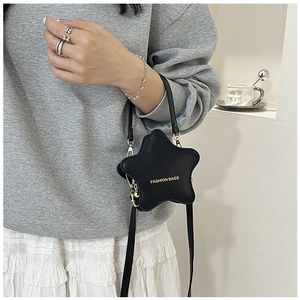Detail of star-shaped black crossbody bag with gold Fashion Bags text and matte PU texture