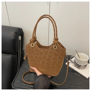 Detail of leopard print tote bag featuring gold FASHINO & BAGS logo and suede texture