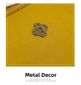 Detail shot of bright yellow nylon handbag with silver four-leaf clover metal buckle