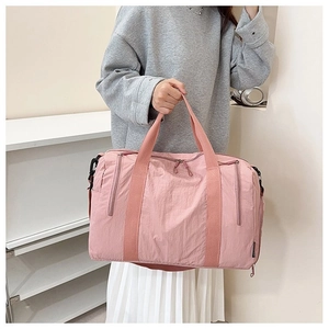 Pink nylon fitness bag detail showing large capacity storage and textured fabric finish