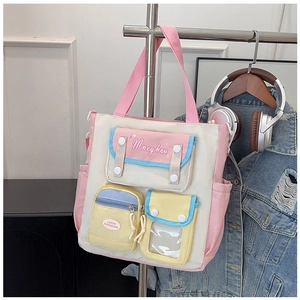 Detailed close-up of multi-color canvas tote bag with functional pockets and emblem