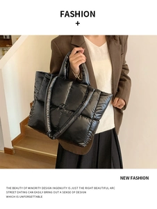 Close-up of a black quilted tote bag with padded texture and large capacity for daily use