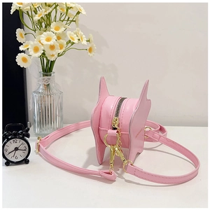 Macro detail of the smooth pink leather and gold zipper on a star-shaped handbag