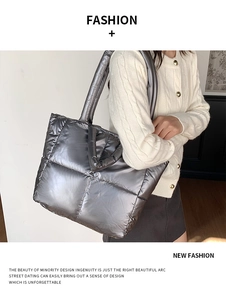 Silver quilted tote bag shown on a model with metallic finish and spacious padded design