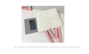 Quilted tote bag size comparison with tablet and phone on white surface