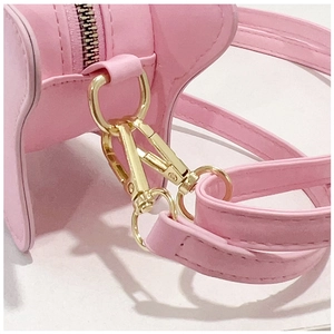 Detailed close-up of pink star mini bag showing golden metal buckle and stitching