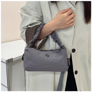 Close-up of gray nylon shoulder bag showing ruched handle and sleek fabric texture
