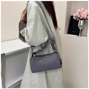 Detail of greyish-purple nylon handbag featuring a unique cloud-like ruched handle design