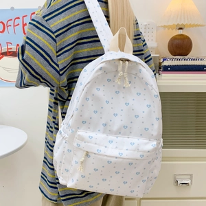 White casual backpack with blue heart and star patterns for students and daily usage
