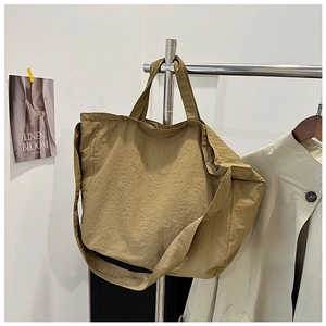 Detail of khaki large capacity canvas tote bag with adjustable wide shoulder strap