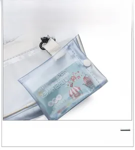 Detail of transparent PVC card holder with white canvas strap and black hook accessory